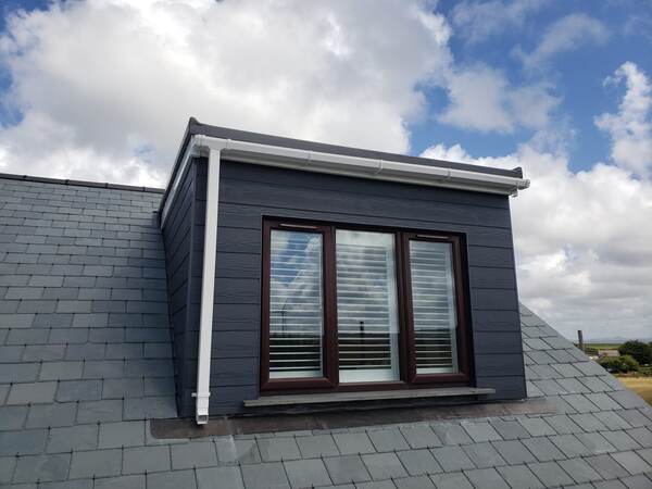 Flat roof dormer with cladding