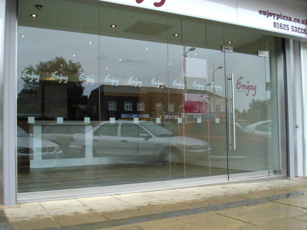 Glass shopfront with patch fittings