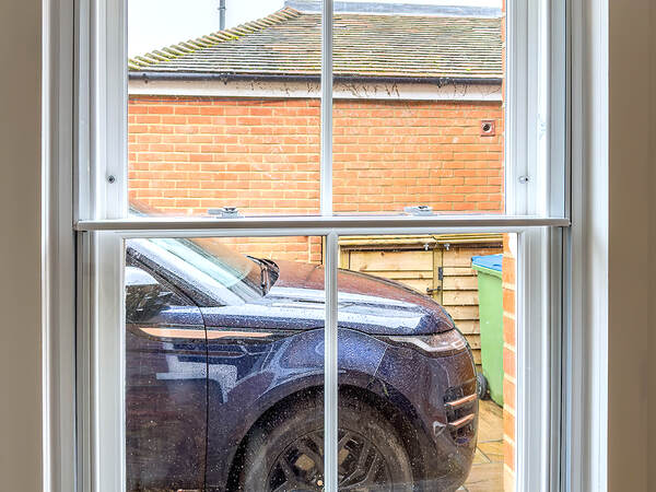 Vertical sliding secondary glazing